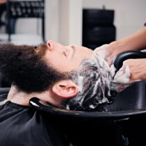 close-up-image-female-hairdresser-washing-bearded-men-s-hair-before-haircut-saloon