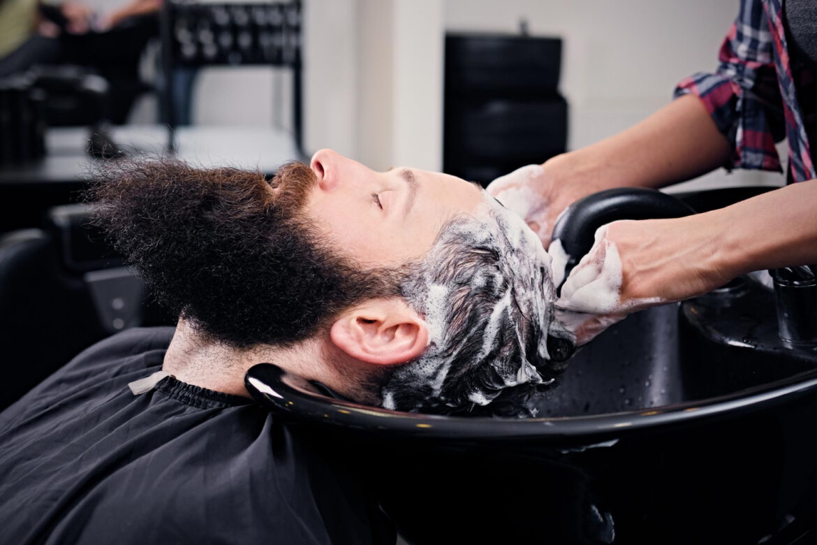 close-up-image-female-hairdresser-washing-bearded-men-s-hair-before-haircut-saloon